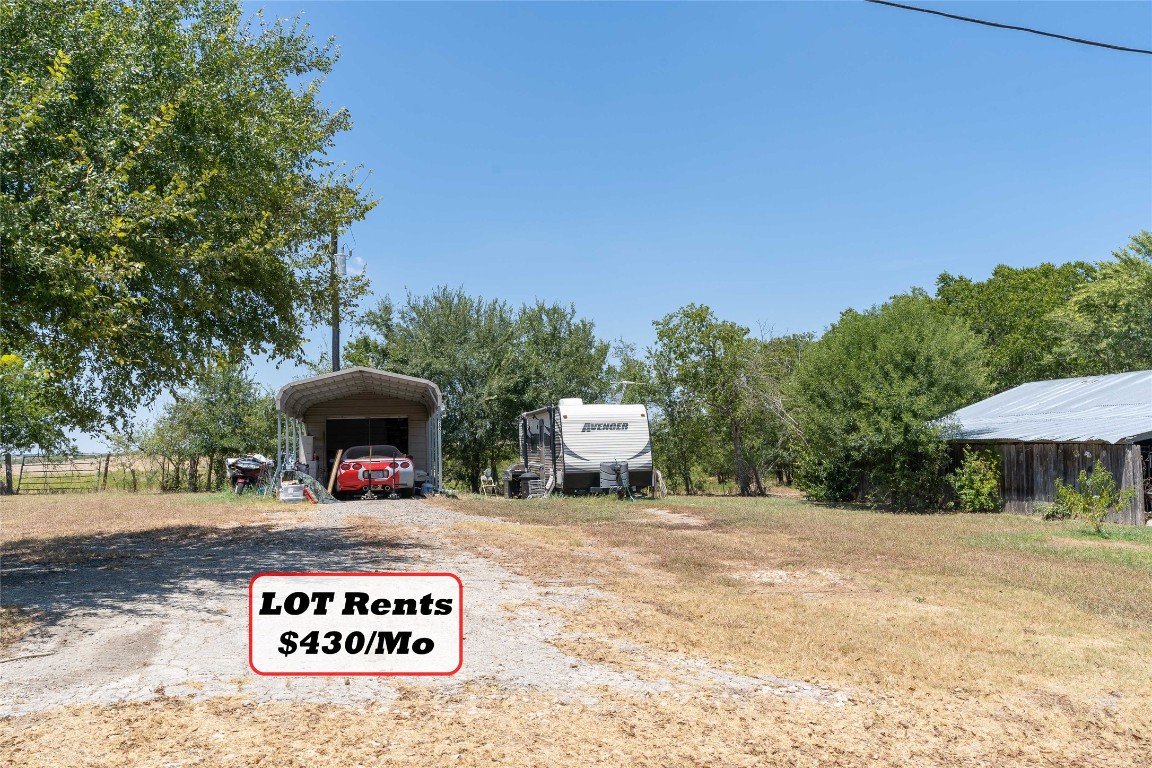 Tbd Tbd Bluebonnet Road Lockhart, TX 78644 - Photo 24 of 32 a view of outdoor space with signage and flags