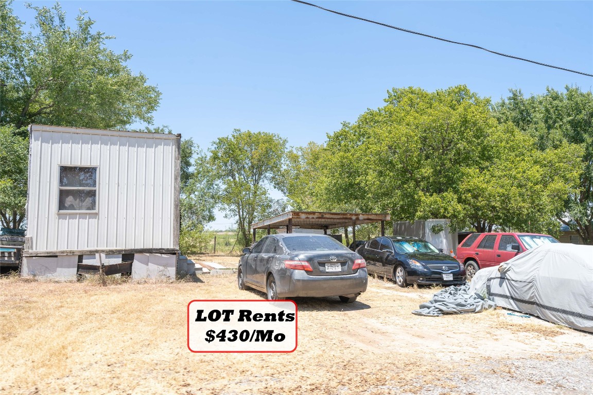 Tbd Tbd Bluebonnet Road Lockhart, TX 78644 - Photo 26 of 32 a view of backyard with a table and chairs and potted plants