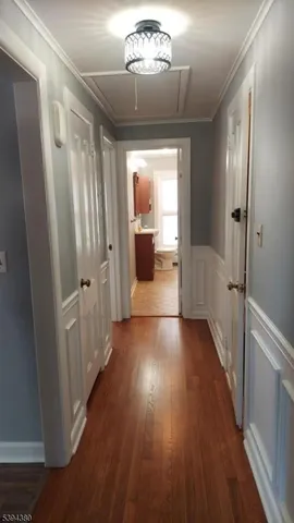 a view of a hallway view with wooden floor and staircase