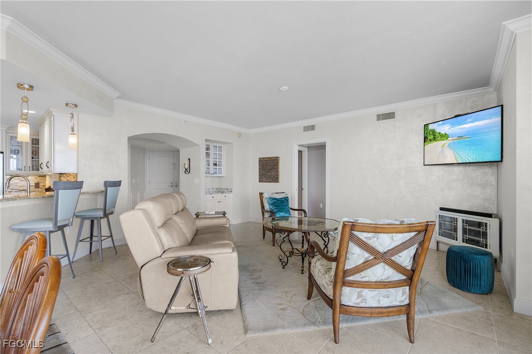 2090 West First Street, Unit 1606 Fort Myers, FL 33901 - Photo 6 of 47 a living room with furniture a rug and white walls