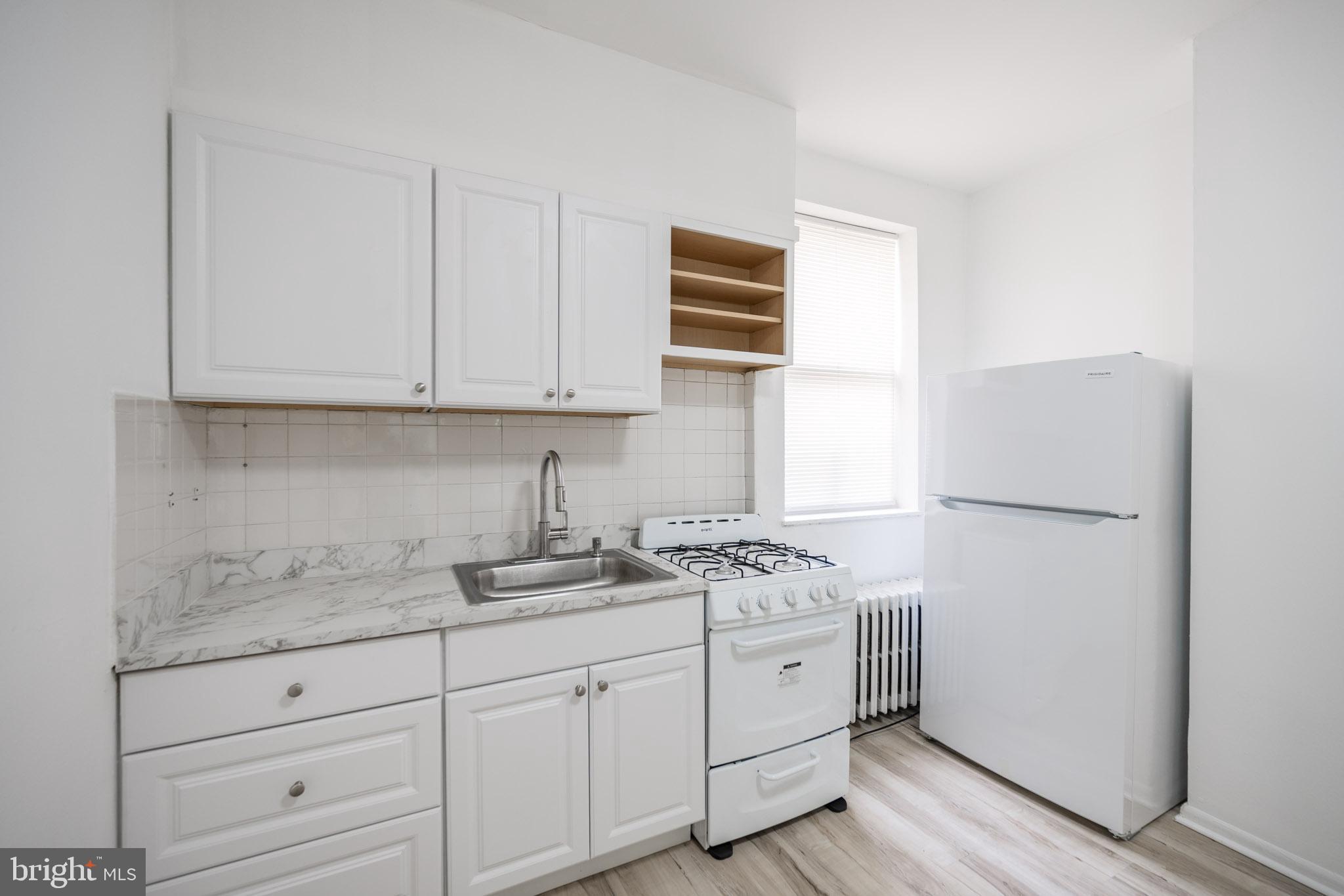 625 South 10th Street, Unit 2F Philadelphia, PA 19147 - Photo 4 of 13 a kitchen with appliances a sink and cabinets