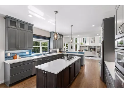 a kitchen with a sink stove and cabinets