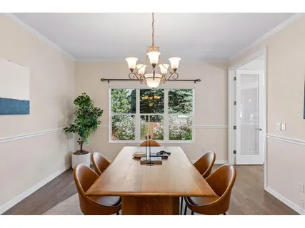a view of a dining room with furniture wooden floor and chandelier