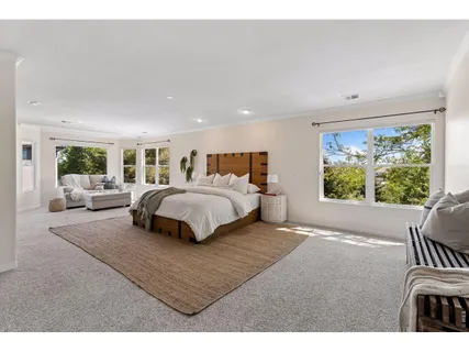 a bedroom with a large bed and a large window