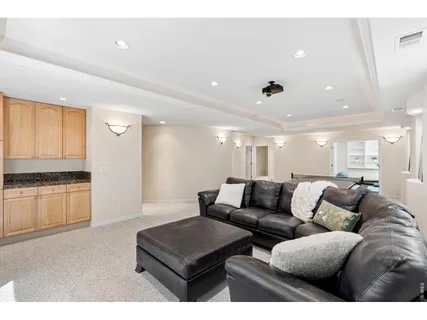 a living room with furniture and a kitchen