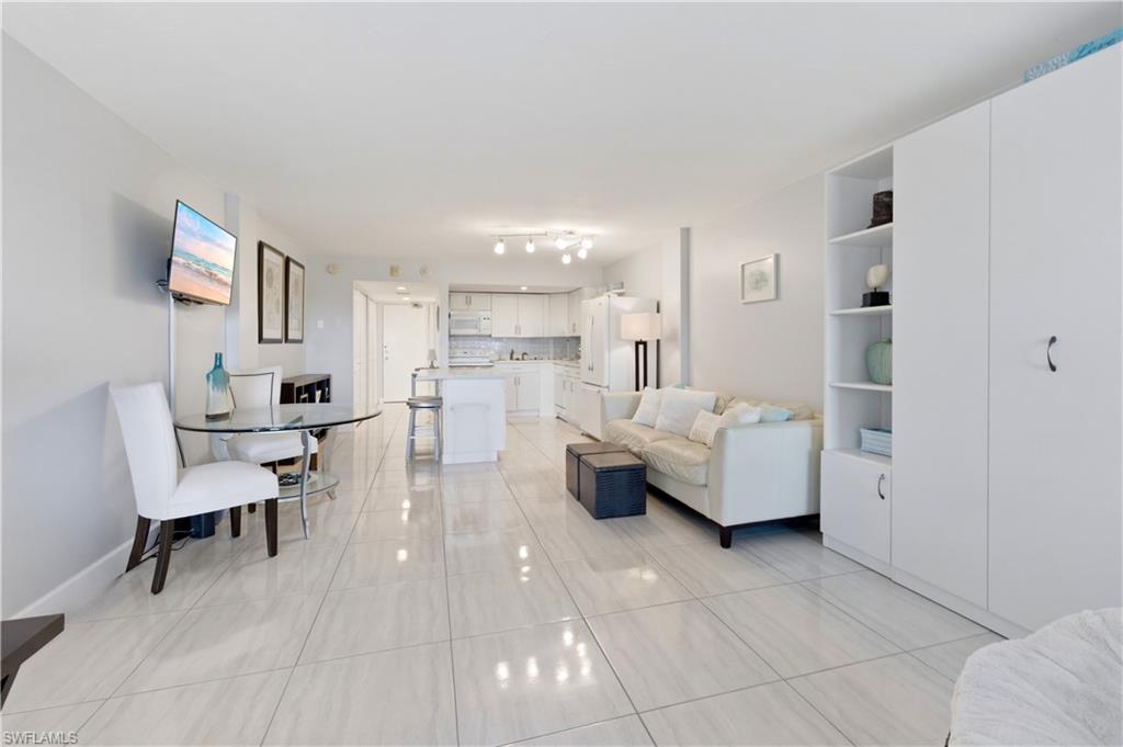 1 Bluebill Avenue, Unit 605 Naples, FL 34108 - Photo 10 of 20 Living area featuring light tile patterned floors and baseboards