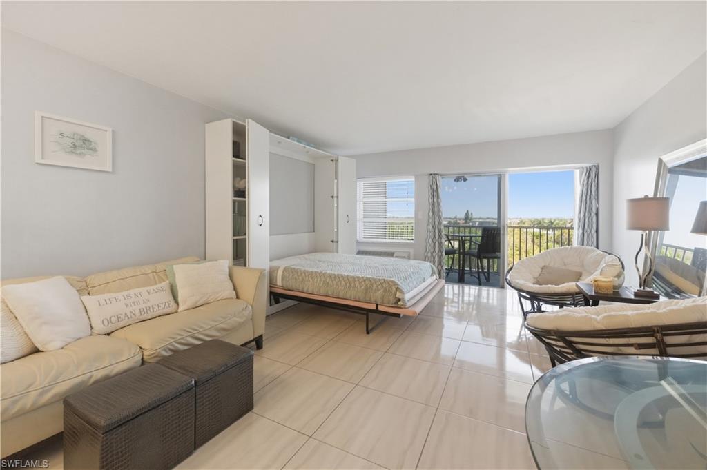 1 Bluebill Avenue, Unit 605 Naples, FL 34108 - Photo 12 of 20 Bedroom featuring tile patterned floors and access to exterior