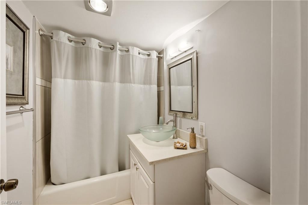 1 Bluebill Avenue, Unit 605 Naples, FL 34108 - Photo 17 of 20 Full bath featuring vanity and shower / tub combo with curtain