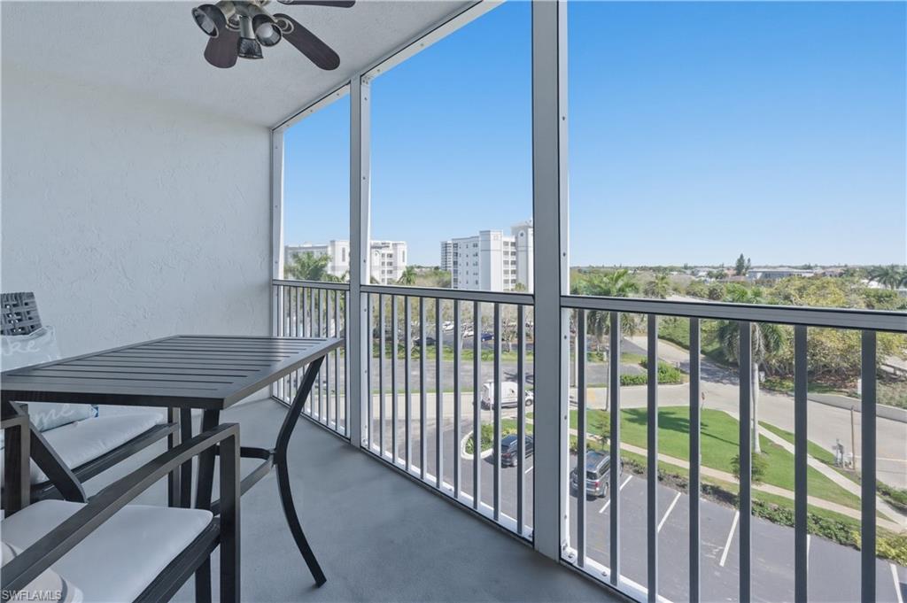 1 Bluebill Avenue, Unit 605 Naples, FL 34108 - Photo 18 of 20 Balcony featuring a sunroom and a ceiling fan