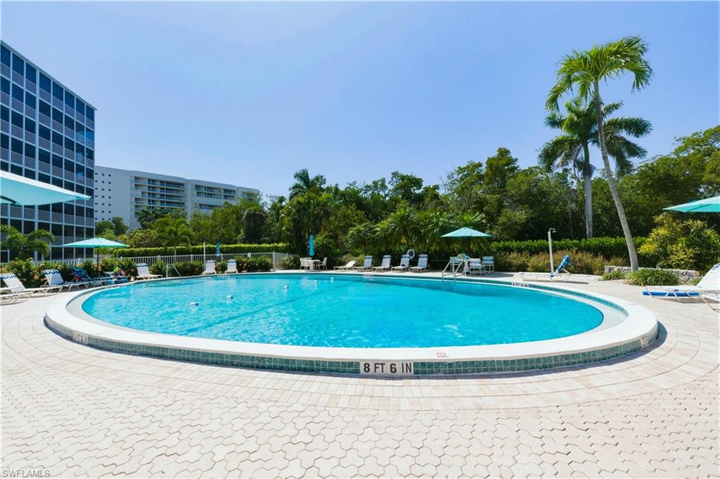 1 Bluebill Avenue, Unit 605 Naples, FL 34108 - Photo 19 of 20 Community pool with a patio