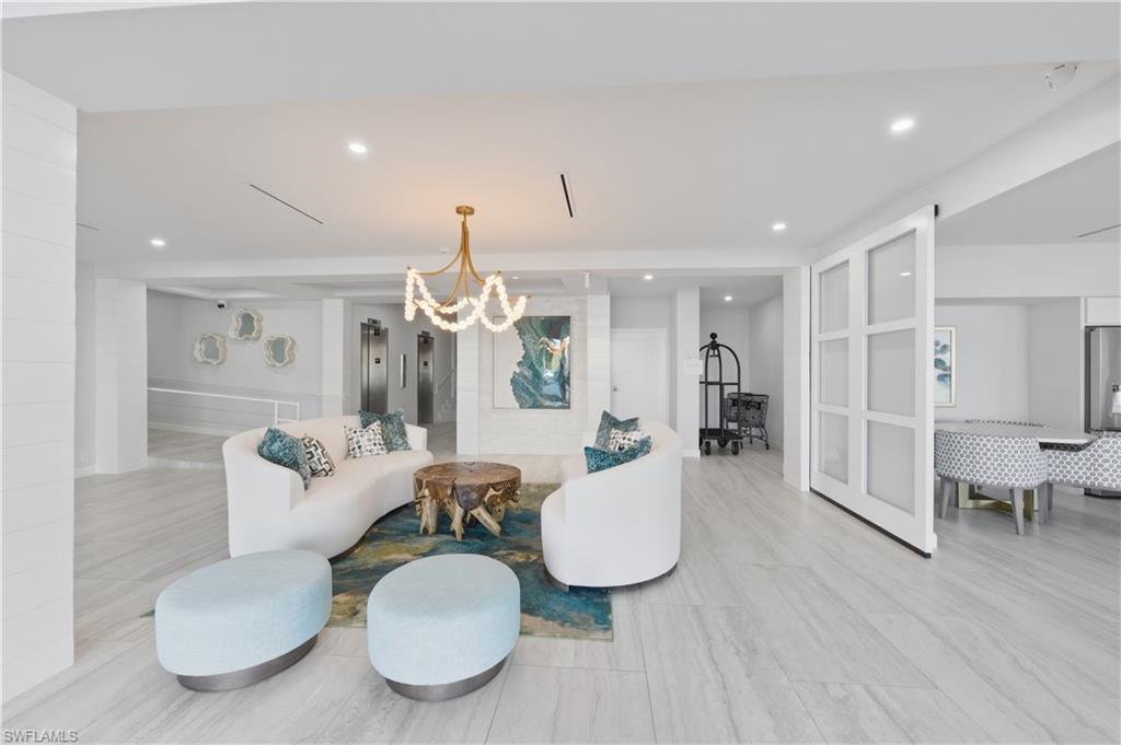 1 Bluebill Avenue, Unit 605 Naples, FL 34108 - Photo 4 of 20 Building Living area featuring elevator and a chandelier