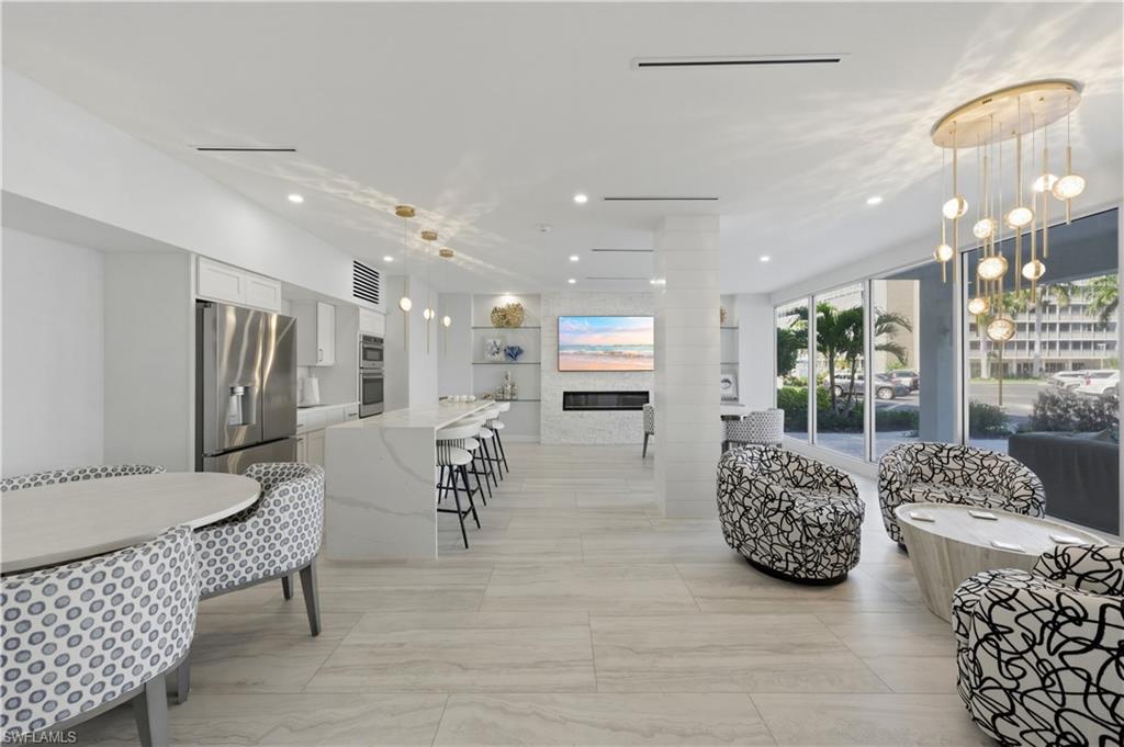 1 Bluebill Avenue, Unit 605 Naples, FL 34108 - Photo 5 of 20 Building Living area featuring recessed lighting and a glass covered fireplace