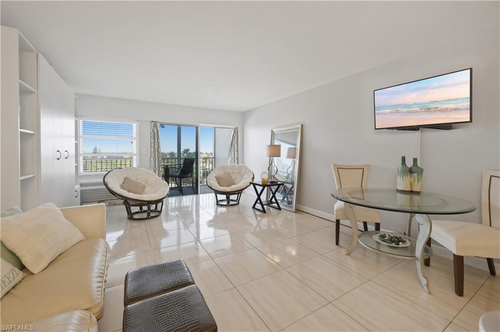 1 Bluebill Avenue, Unit 605 Naples, FL 34108 - Photo 8 of 20 Living room featuring light tile patterned floors and baseboards
