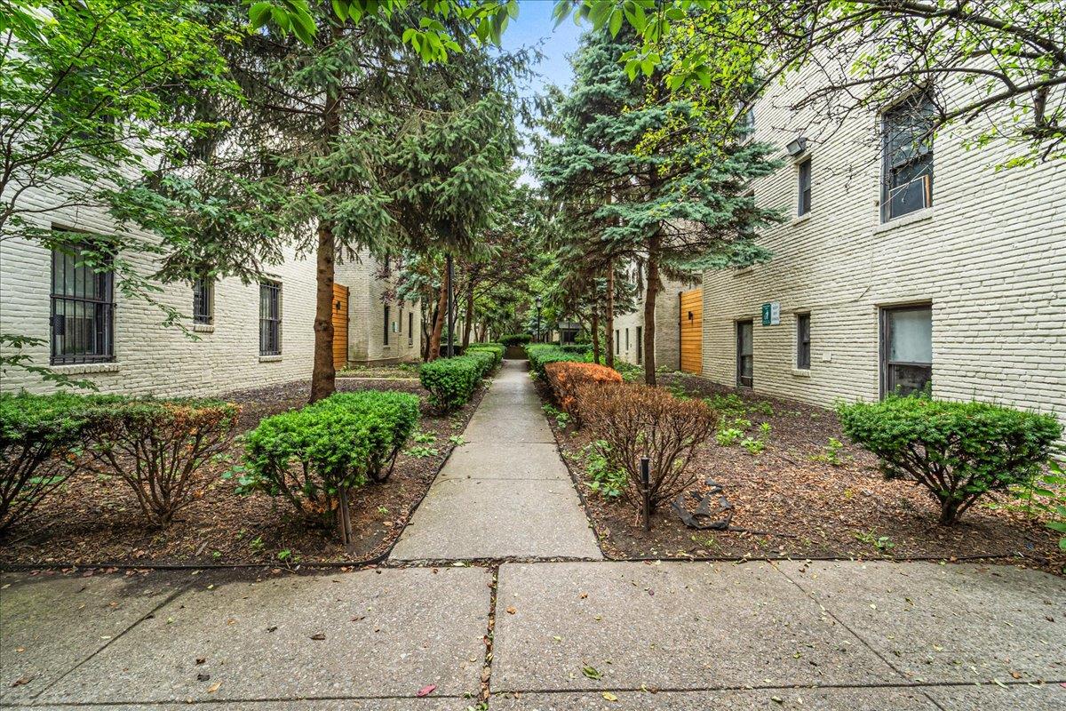 21-37 33rd Street, Unit 3D Queens, NY 11105 - Photo 13 of 15 a view of a brick house with a yard and large tree