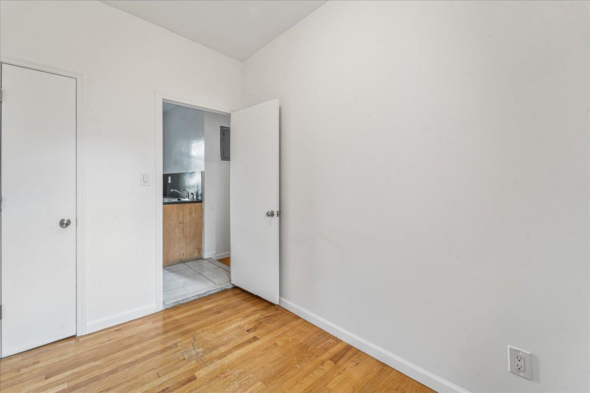 21-37 33rd Street, Unit 3D Queens, NY 11105 - Photo 9 of 15 a view of empty room with wooden floor
