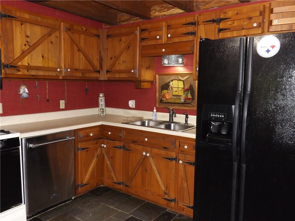 167 Bonniebrook Road Butler, PA 16002 - Photo 17 of 25 a kitchen with a sink and a refrigerator