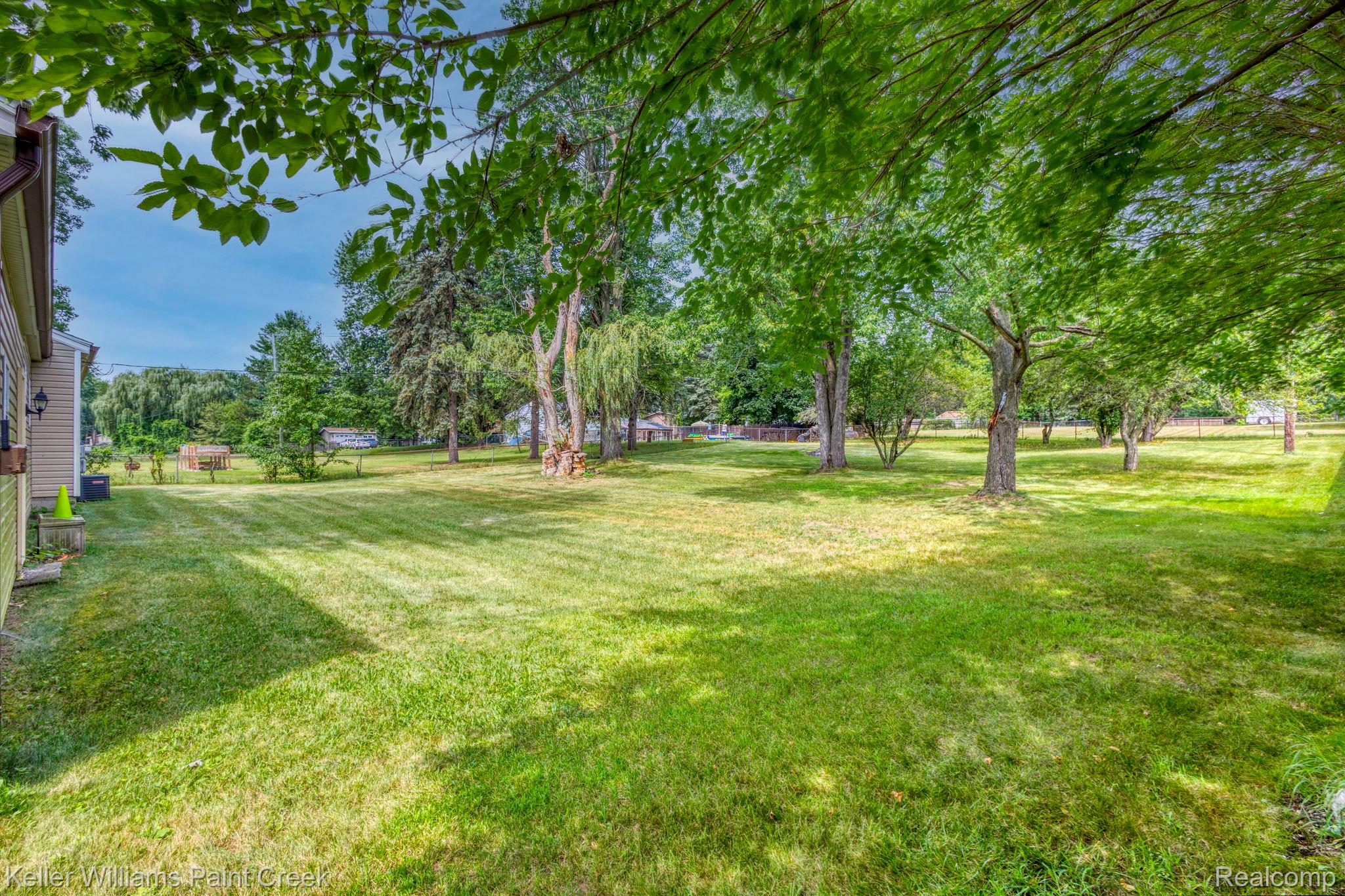 2244 Hammerslea Road Lake Orion, MI 48359 - Photo 15 of 21 Expansive grassy yard with mature trees