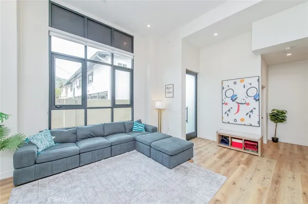 a living room with furniture and a floor to ceiling window
