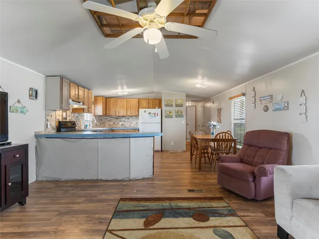 a living room with furniture and kitchen view