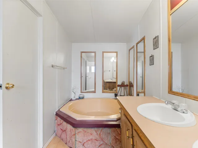 a bath room with a sink and a mirror