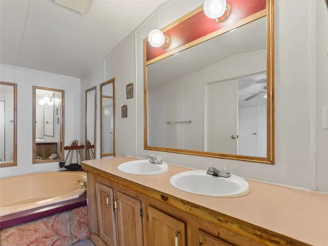 a bathroom with a double vanity sink and a mirror