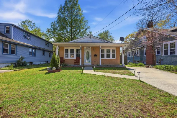 a view of a house with a yard and plants