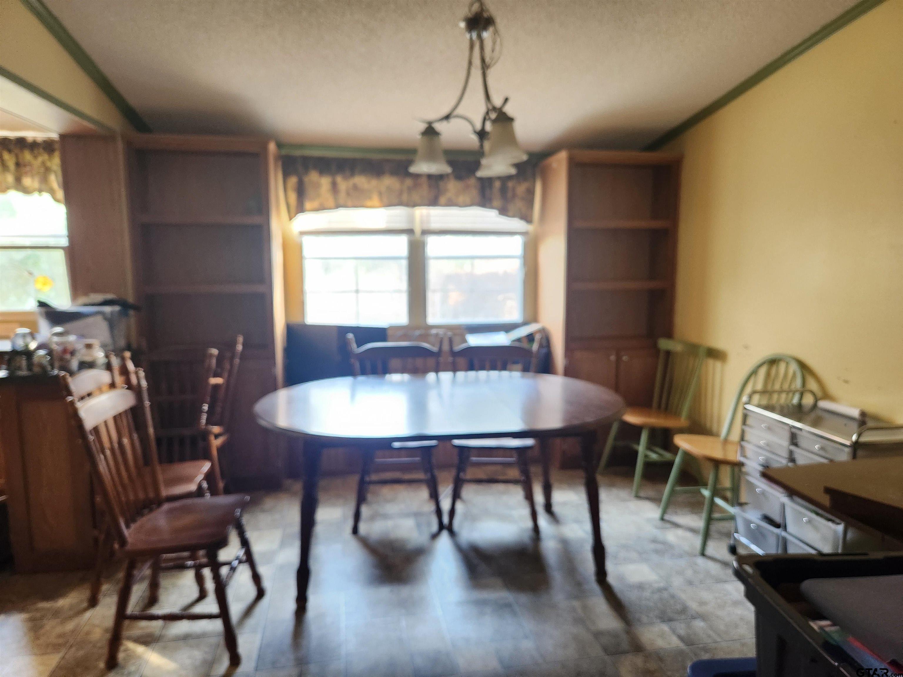 11308 E Creek Tyler, TX 75708 - Photo 6 of 14 a dining room with furniture a chandelier and window