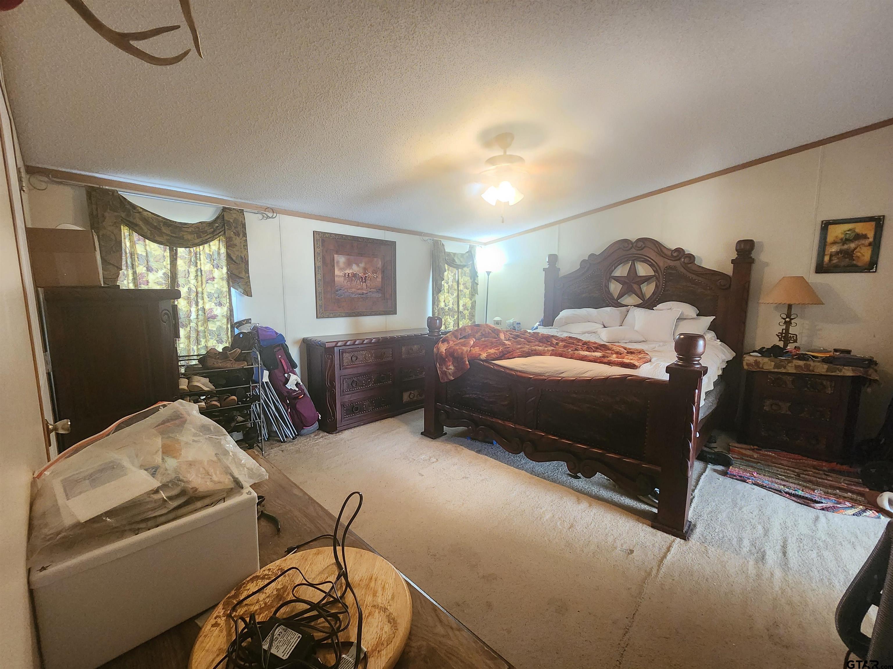 11308 E Creek Tyler, TX 75708 - Photo 7 of 14 a bedroom with bed couch and window