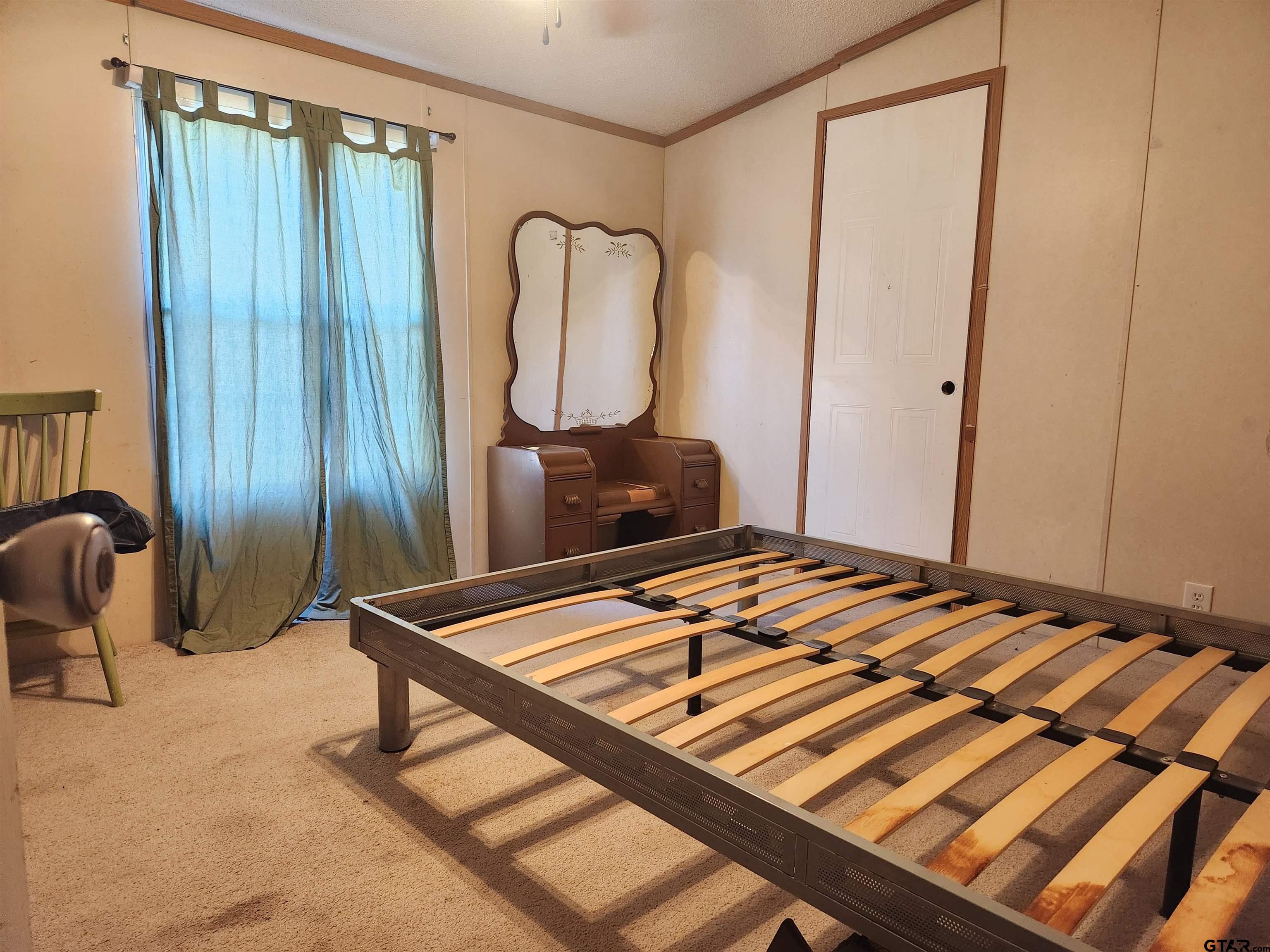 11308 E Creek Tyler, TX 75708 - Photo 9 of 14 a living room with a bed and furniture