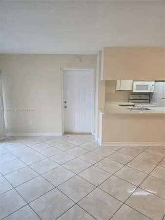 a view of kitchen and empty room