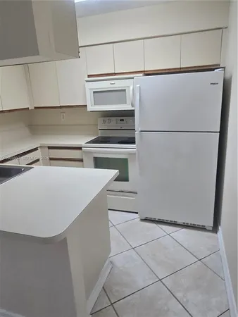 a kitchen with stainless steel appliances a refrigerator and a stove top oven