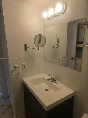 a bathroom with a sink and mirror