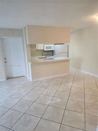 a room with a cabinets and utility room view