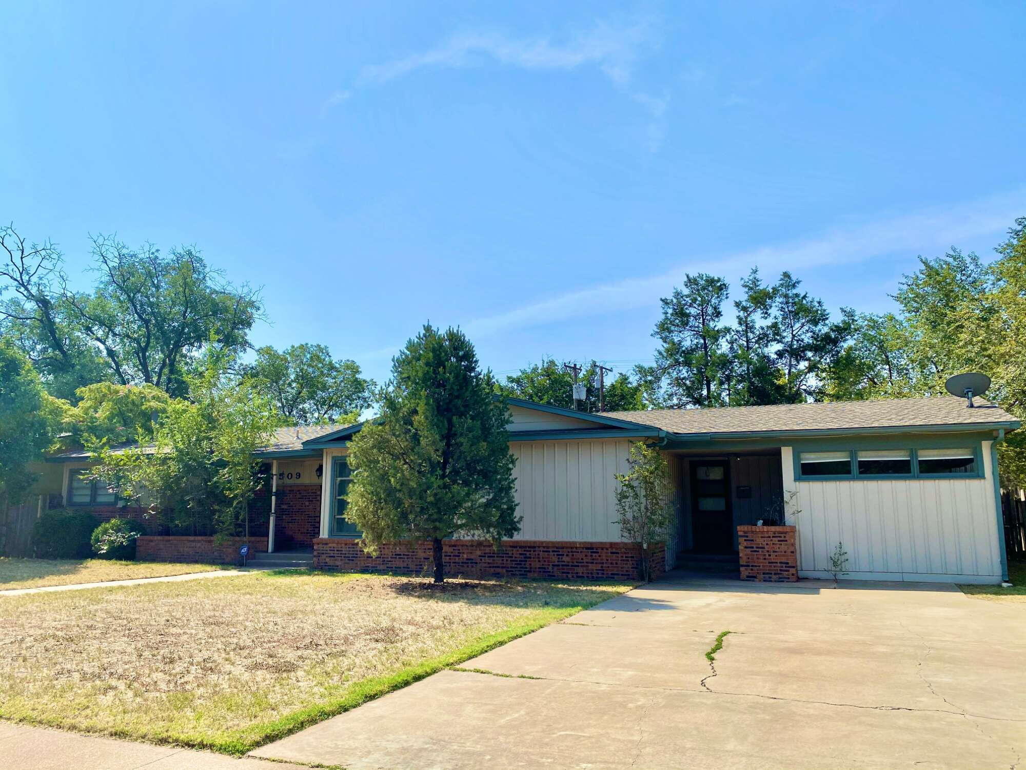 3509 37th Street Lubbock, TX 79413 - Photo 1 of 24 a house with trees in the background