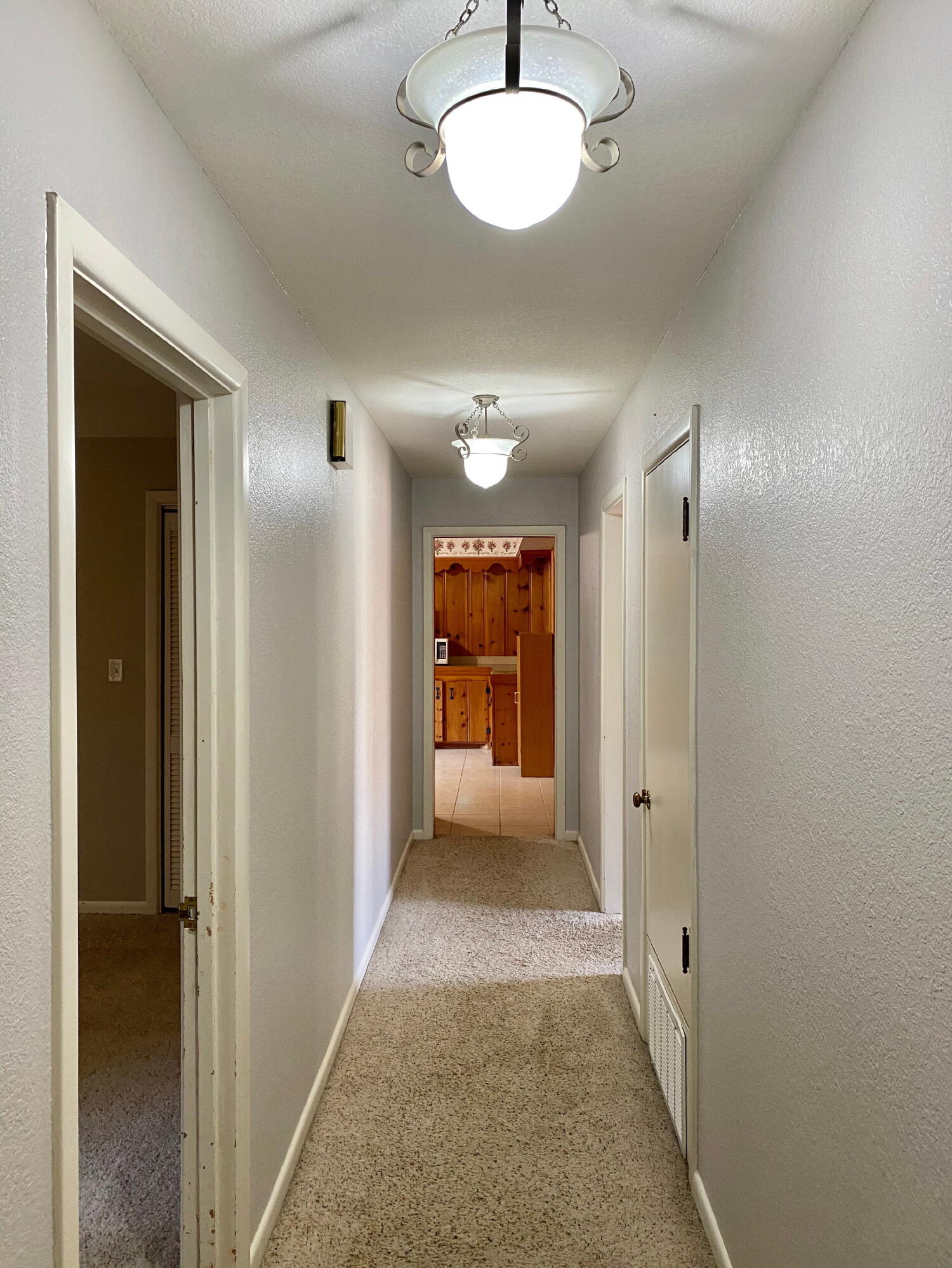 3509 37th Street Lubbock, TX 79413 - Photo 11 of 24 a view of a hallway with wooden shelves
