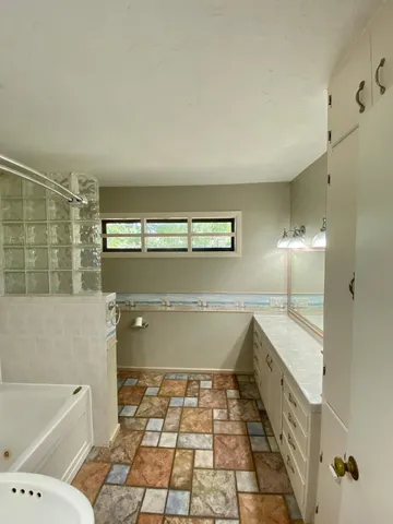 a bathroom with a sink toilet a mirror and shower