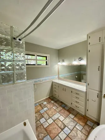 a bathroom with a bathtub and a sink