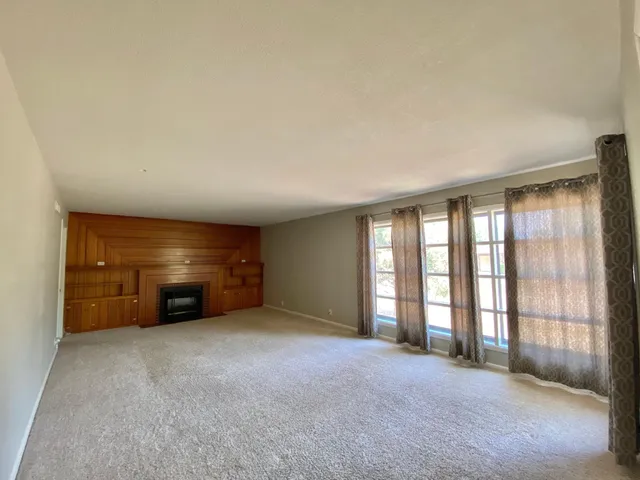 an empty room with furniture and a window