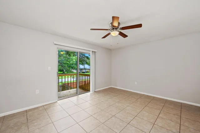 a view of a livingroom with a ceiling fan and window