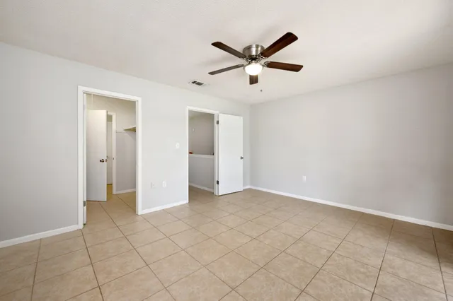 a view of a livingroom with a ceiling fan and window