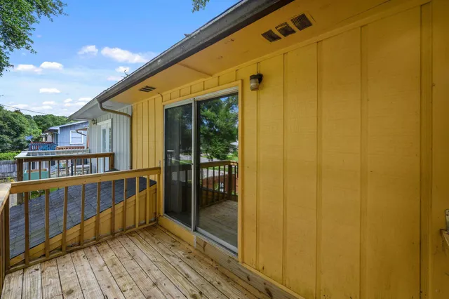 a view of a balcony with wooden floor and outdoor space