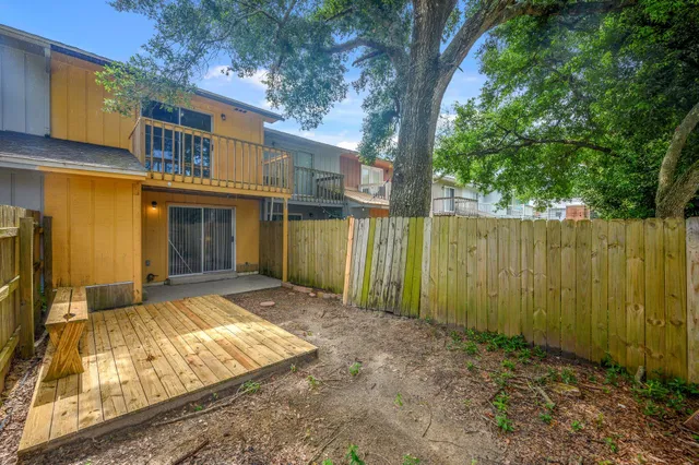 a view of a house with a wooden fence