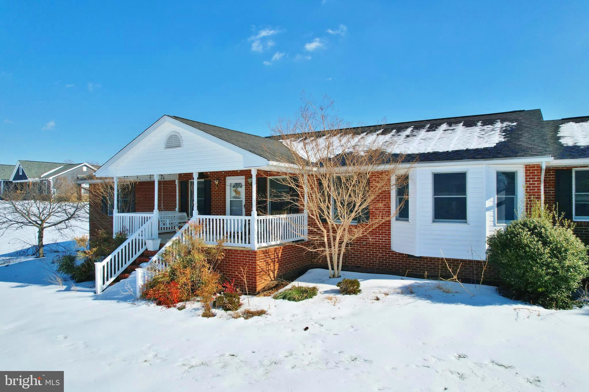 a front view of a house with a yard outdoor seating and garage