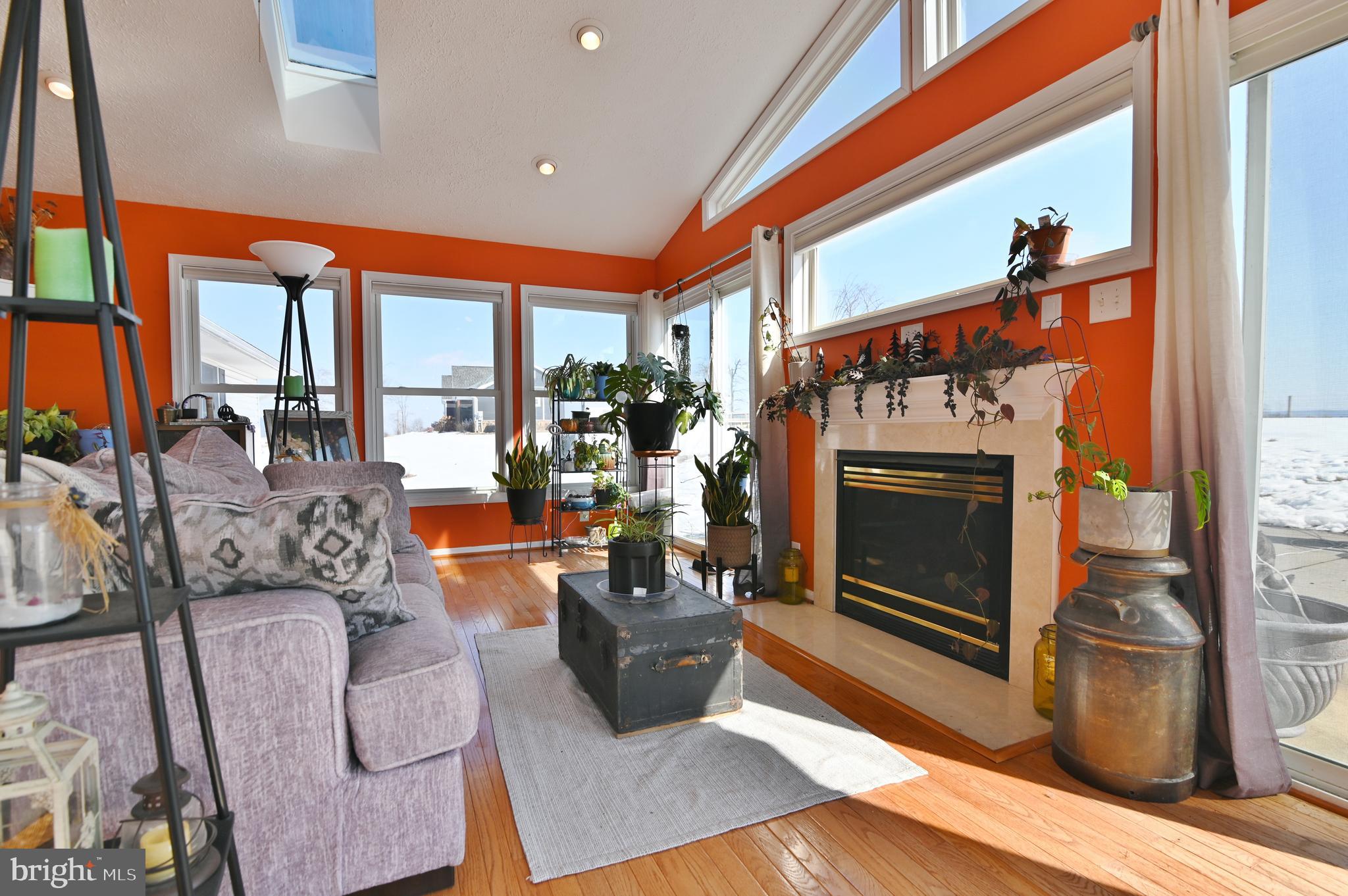 8284 Back Road Maurertown, VA 22644 - Photo 25 of 54 a living room with furniture a fireplace and a floor to ceiling window
