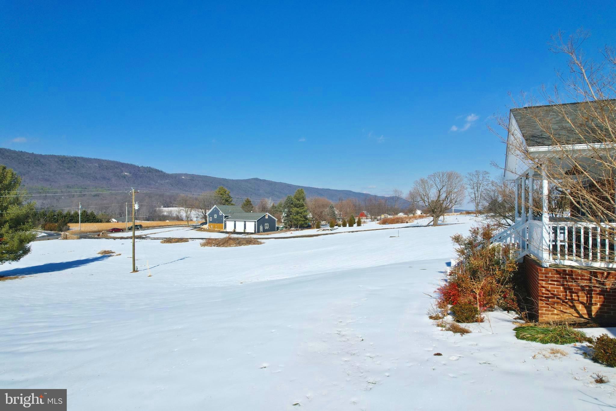 8284 Back Road Maurertown, VA 22644 - Photo 10 of 54 a view of a terrace with glass top table and chairs