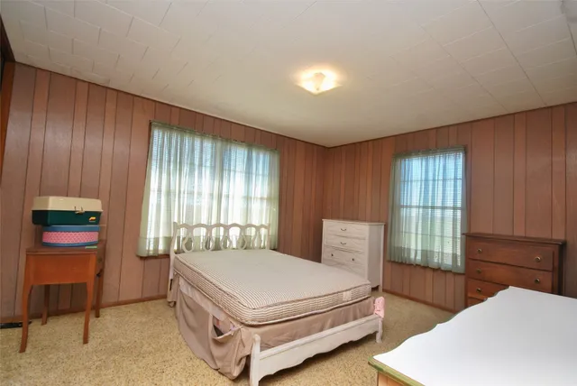 a bedroom with a bed and window