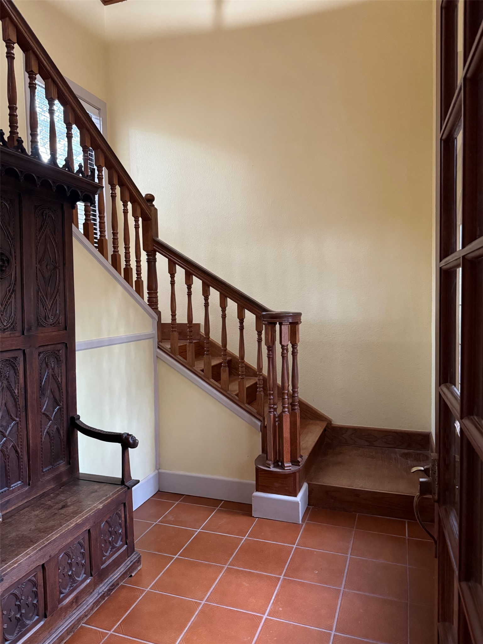 363 Porter Road Bastrop, TX 78602 - Photo 31 of 37 An elegant entry features timeless tile flooring and a classic wooden staircase with detailed banisters.
