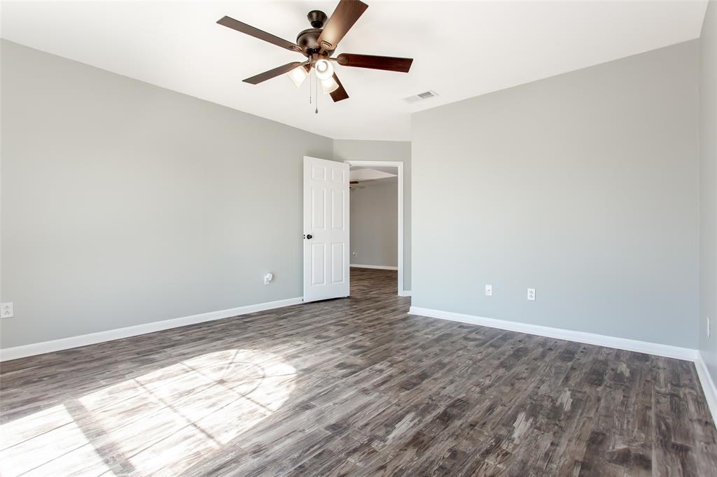 712 Billups Street Van Alstyne, TX 75495 - Photo 22 of 38 wooden floor in an empty room