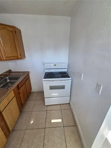 a kitchen with a refrigerator and a stove