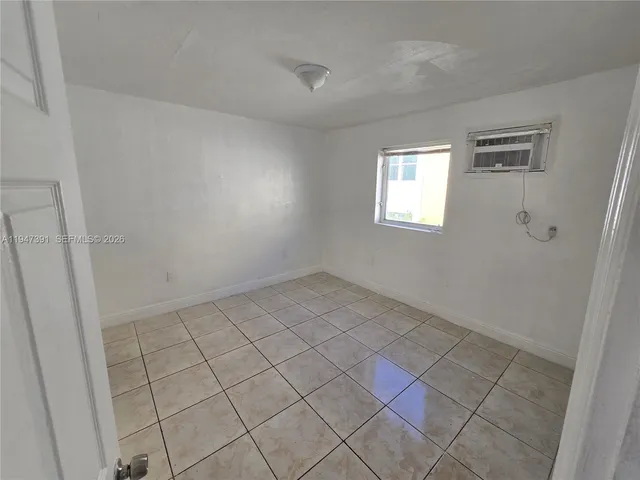 a view of an empty room and window